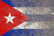 Cuba flag on a damaged old concrete wall surface