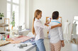 © Studio Romantic - Female seamstress or designer measuring client with tape create design garment in own workshop. Woman tailor or dressmaker work with customer in fashion studio or atelier. Clothing manufacturing.