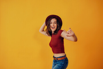 Woman with red hat dancing in studio portrait studio portrait