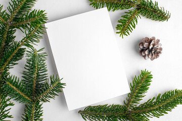 Wall Mural - Christmas 5x7 card mockup template with fir twigs on white background. Design element for Christmas and New Year congratulation, rsvp, thank you, greeting or invitation card