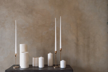 Wall Mural - Set of white candles stand on wooden table