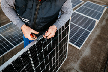 Worker installing new solar panels. Eco concept alternative energy