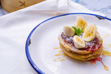Wall Mural - pancake with bananas and raspberry jam on plate