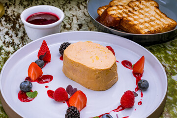 Poster - terrine de foie gras on grey plate with berries macro close up