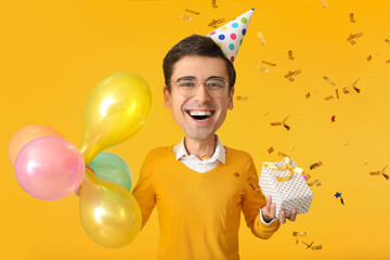 Poster - Happy funny man with big head celebrating birthday on orange background