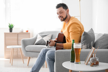 Canvas Print - Handsome man playing guitar at home