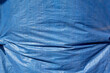 A view of a blue tarp, as a background.