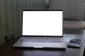 Wall Mural - Computer laptop with blank screen on table of coffee shop, mockup notebook laptop empty screen for editing graphics for ads..