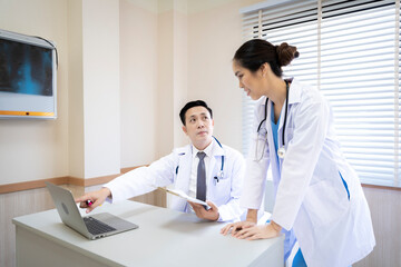 Wall Mural - Male and female doctor, good looking, Asian, Thailand. Discussions are discussed in the hospital office about the patient's disease.