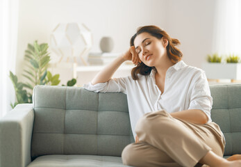 Wall Mural - woman resting on a sofa