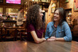 © Westend61 - Two female friends talking in a pub