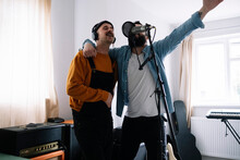 Musicians Singing Together With Microphone At Home Studio