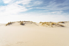 Sand Dunes Under Cloudy Sky On Sunny Day