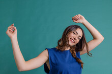 Happy Woman Dancing Against Blue Background