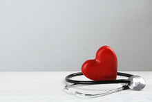 Stethoscope And Red Heart On White Wooden Table, Space For Text. Cardiology Concept