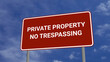 Private Property No Trespassing Road Sign on Clear Blue Sky with Rapid Moving Clouds