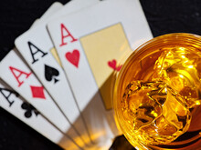 Glass Of Whiskey With Ice Cubes On Poker Playing Cards With Four Aces. Poker Game Gambling And Whisky