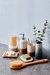 Brush for body massage, washcloth and other toiletries on table in bathroom
