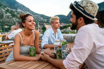 Wall Mural - Leisure holidays vacation people and food concept. Happy friends having dinner at summer party