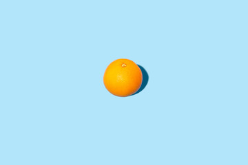 Sticker - Fresh orange on a blue background. Top view, flat lay.