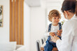 © bnenin - Smiling toddler enjoying his doctor appointment, using stethosco