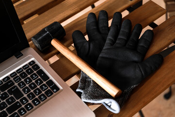 Wall Mural - 
Worker in his work area with a computer, gloves and a mallet hammer