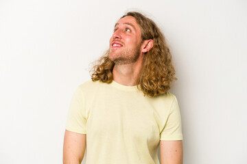 Young caucasian man isolated on white background relaxed and happy laughing, neck stretched showing teeth.