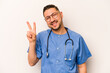 © Asier - Hispanic nurse man isolated on white background joyful and carefree showing a peace symbol with fingers.