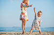 © AS Photo Family - Mother and beautiful daughter having fun on the beach. Portrait of happy woman with cute little girl on vacation.