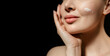 Skin care. Close up beauty portrait of young woman applay cream. Isolated on black background, Web banner