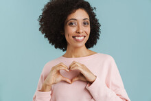 Young Black Woman Smiling And Making Heart Gesture