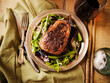 © Michael Marquand - Sliced Grass Fed Sirloin Steak on a Bed of greens