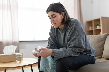 Wall Mural - mental health, stress and depression - sad woman popping bubble wrap at home