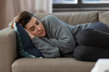 Wall Mural - mental health, psychological problem and depression concept - stressed woman lying on sofa at home