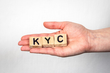 Wall Mural - KYC Know Your Customer. Alphabet letters in a woman's hand on a white background
