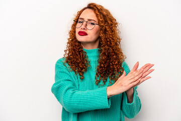 Wall Mural - Young ginger caucasian woman isolated on white background feeling energetic and comfortable, rubbing hands confident.