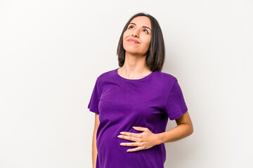 Wall Mural - Young hispanic pregnant woman isolated on white background dreaming of achieving goals and purposes