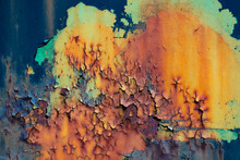 Peeled Off Paint On Rusty Vehicle Surface Of A Ruined Train. Vintage Metal Background With Wheathered Rotten Color And Massive Corrosion In Shades And Gradients Of Orange, Yellow, Green, Blue, Brown