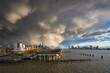 Passing storms over Manhattan at sunset along Hudson River Park. Views on West Village, World Trade Center and Downtown Jersey City. New York City, USA