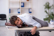 © Elnur - Young male employee in oversleeping concept