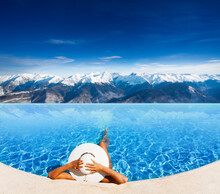 Woman In Rooftop Pool With The View Of Mont Blanc Alps Panorama