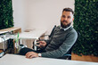 © Zamrznuti tonovi - Handsome businessman sitting at his desk in the office