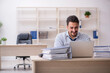 © Elnur - Young male employee and too much work in the office