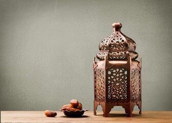 Poster - A Arabian Muslim lantern is placed on a wooden table. Muslim feast of the holy month of Ramadan Kareem.