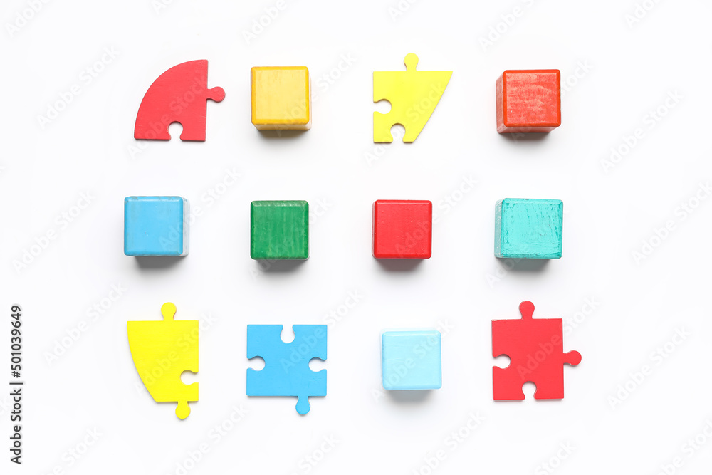 Colorful cubes with puzzle pieces on white background
