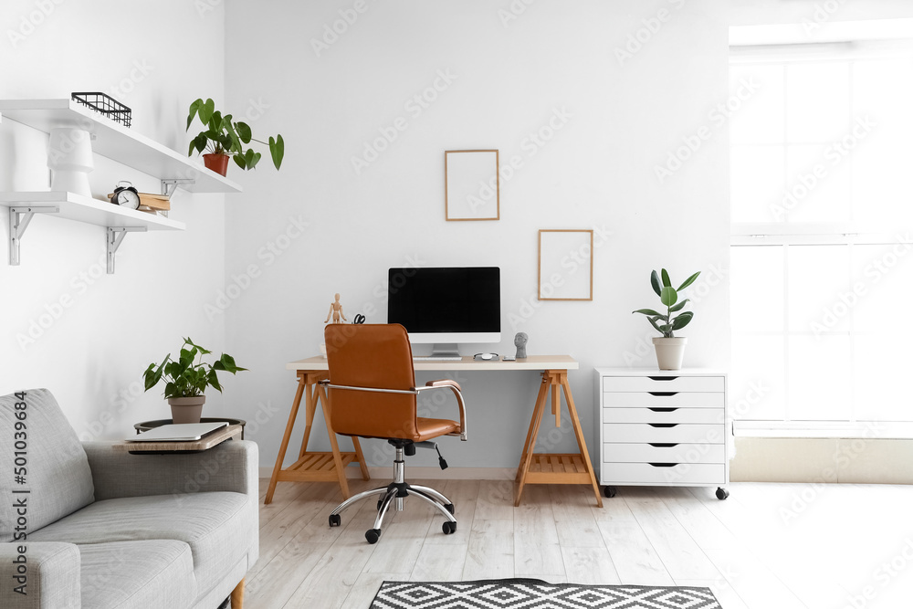 Light interior of room with comfortable workplace and modern computer ...