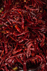 Chiles de árbol placed on a shelf for sale within a market