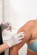 doctor cosmetologist makes an injection in the arm of the patient. mesotherapy procedure to remove excess fat from the body