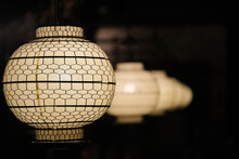 Traditional Chinese Lanterns In A Row In Dark Night. Asian Lanterns In Diminishing Perspective With Black Background