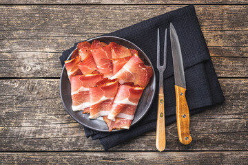 Wall Mural - Sliced schwarzwald ham. Dried prosciutto ham on plate.